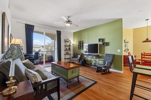 a living room with furniture a rug and a flat screen tv