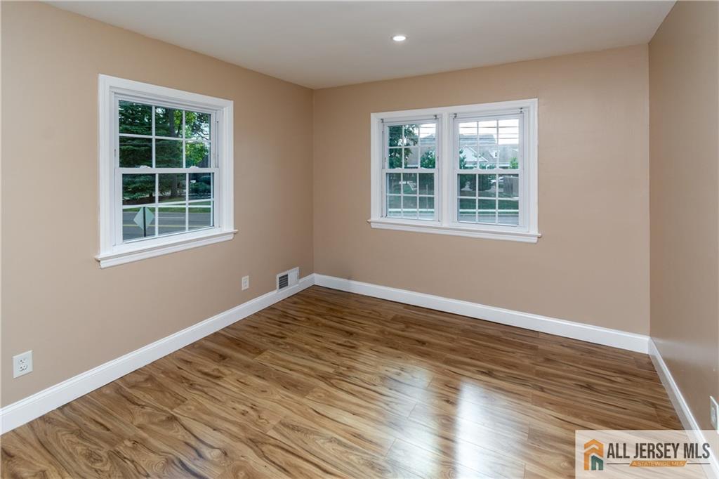 24 Old New Brunswick Road Piscataway, NJ 08854 - Photo 12 of 27 an empty room with wooden floor and windows