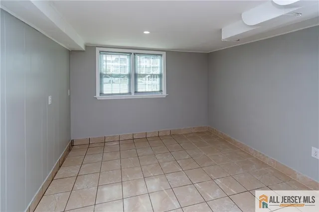 an empty room with white walls and tiles
