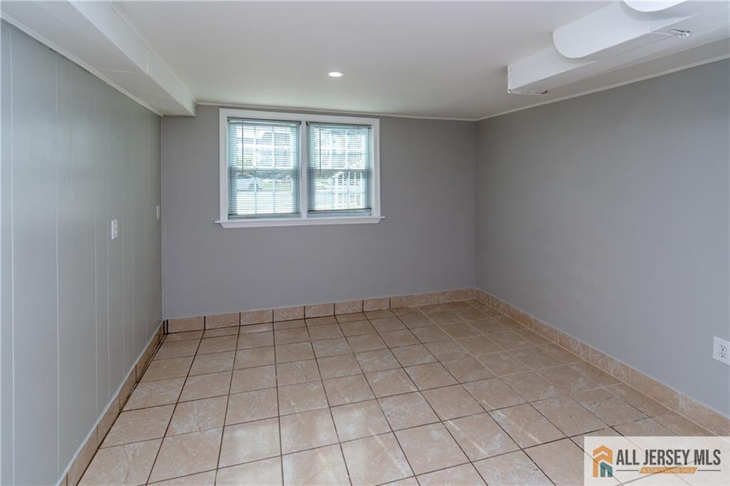 24 Old New Brunswick Road Piscataway, NJ 08854 - Photo 14 of 27 an empty room with white walls and tiles