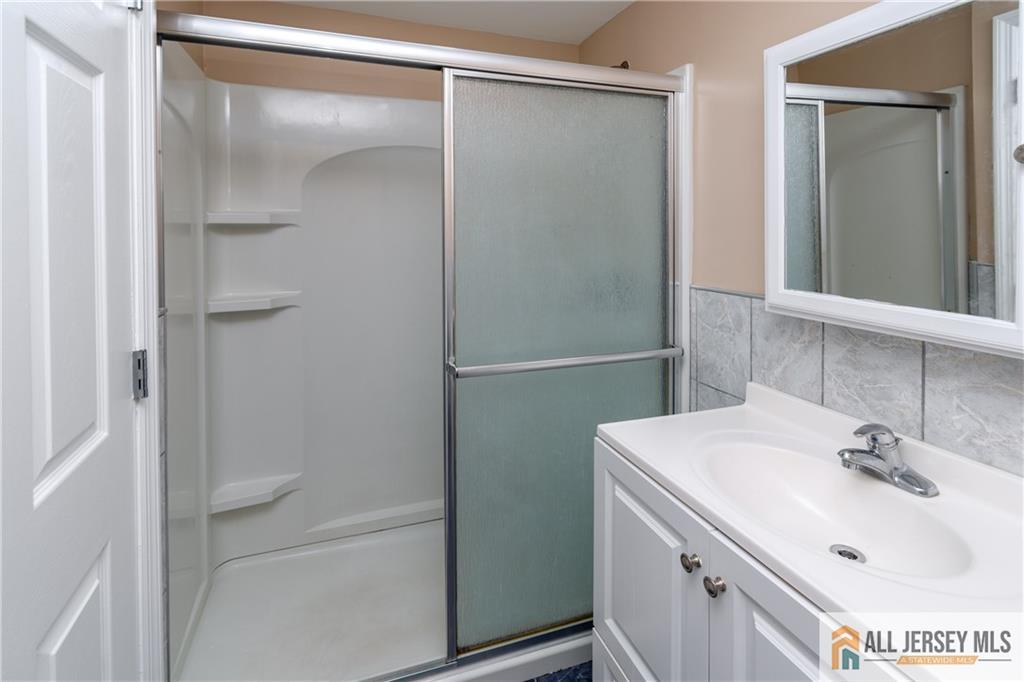 24 Old New Brunswick Road Piscataway, NJ 08854 - Photo 16 of 27 a bathroom with a sink and a mirror
