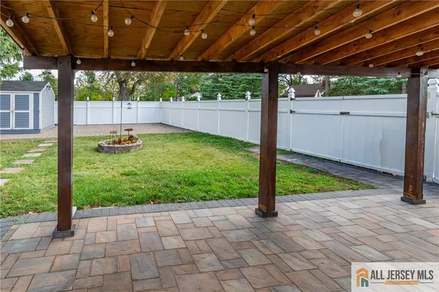 a backyard view with a sink and garden