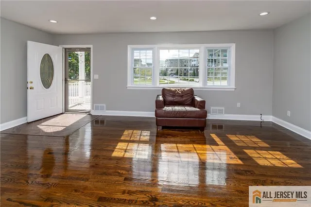 a living room with furniture window and wooden floor