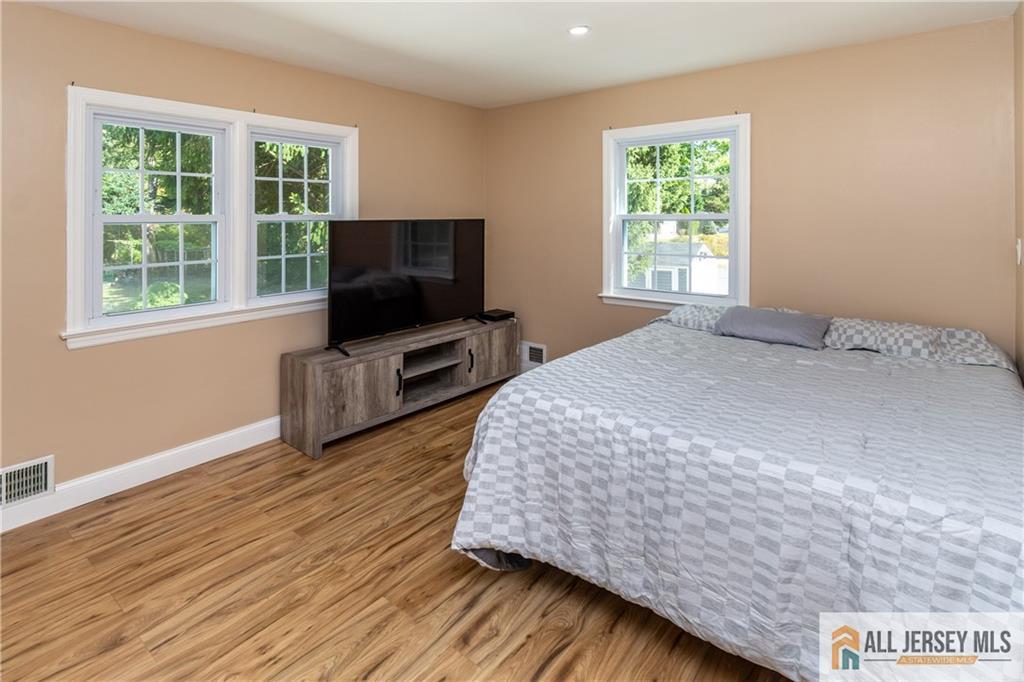 24 Old New Brunswick Road Piscataway, NJ 08854 - Photo 9 of 27 a bedroom with a bed and a flat screen tv