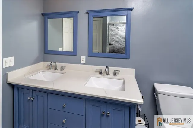 a bathroom with a toilet sink and mirror