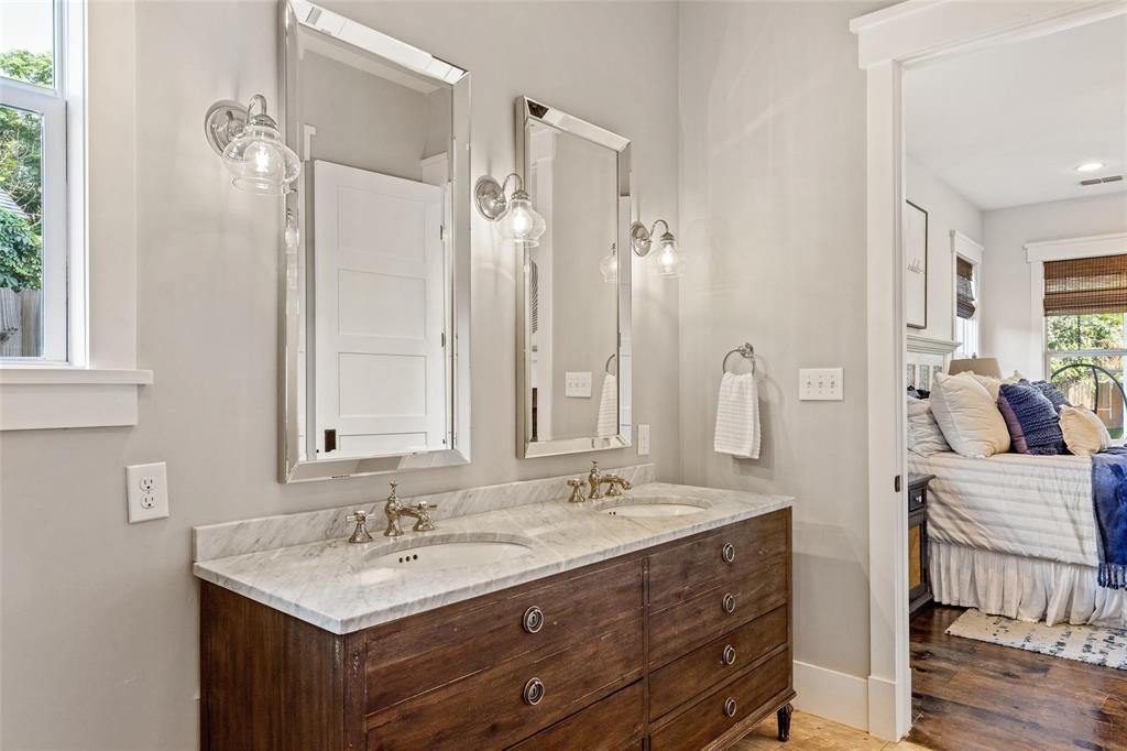 1109 East Oakdale Road Irving, TX 75060 - Photo 12 of 33 a bathroom with a double vanity sink mirror and shower