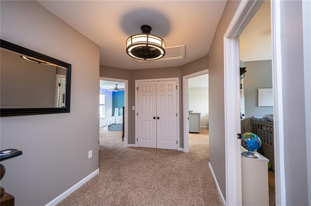 132 Granite Ridge Circle Mars, PA 16046 - Photo 16 of 25 Upstairs is an extra wide hall-way that leads to the bedrooms. The updated lighting/fan keeps air moving for a very comfortable space!