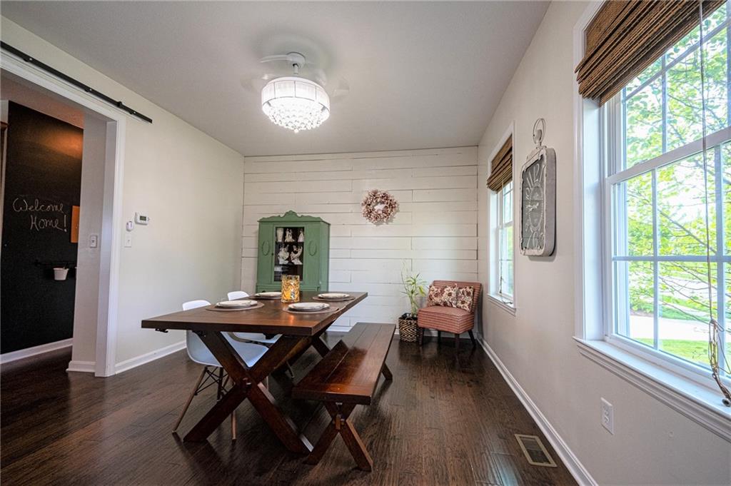132 Granite Ridge Circle Mars, PA 16046 - Photo 4 of 25 Elegant dining room with beautiful hard wood floors and a gorgeous wood plank feature wall!