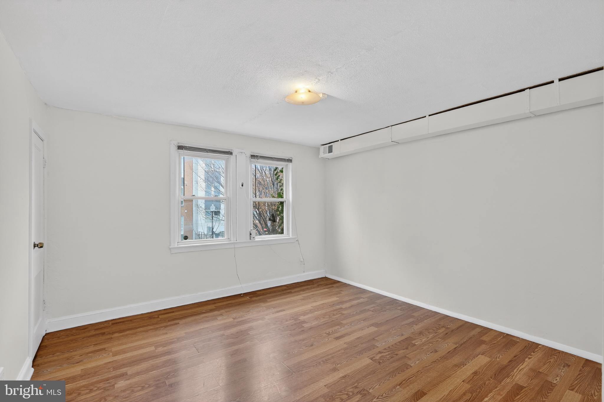1711 H Street Northeast Washington, DC 20002 - Photo 12 of 15 a view of empty room with wooden floor and fan