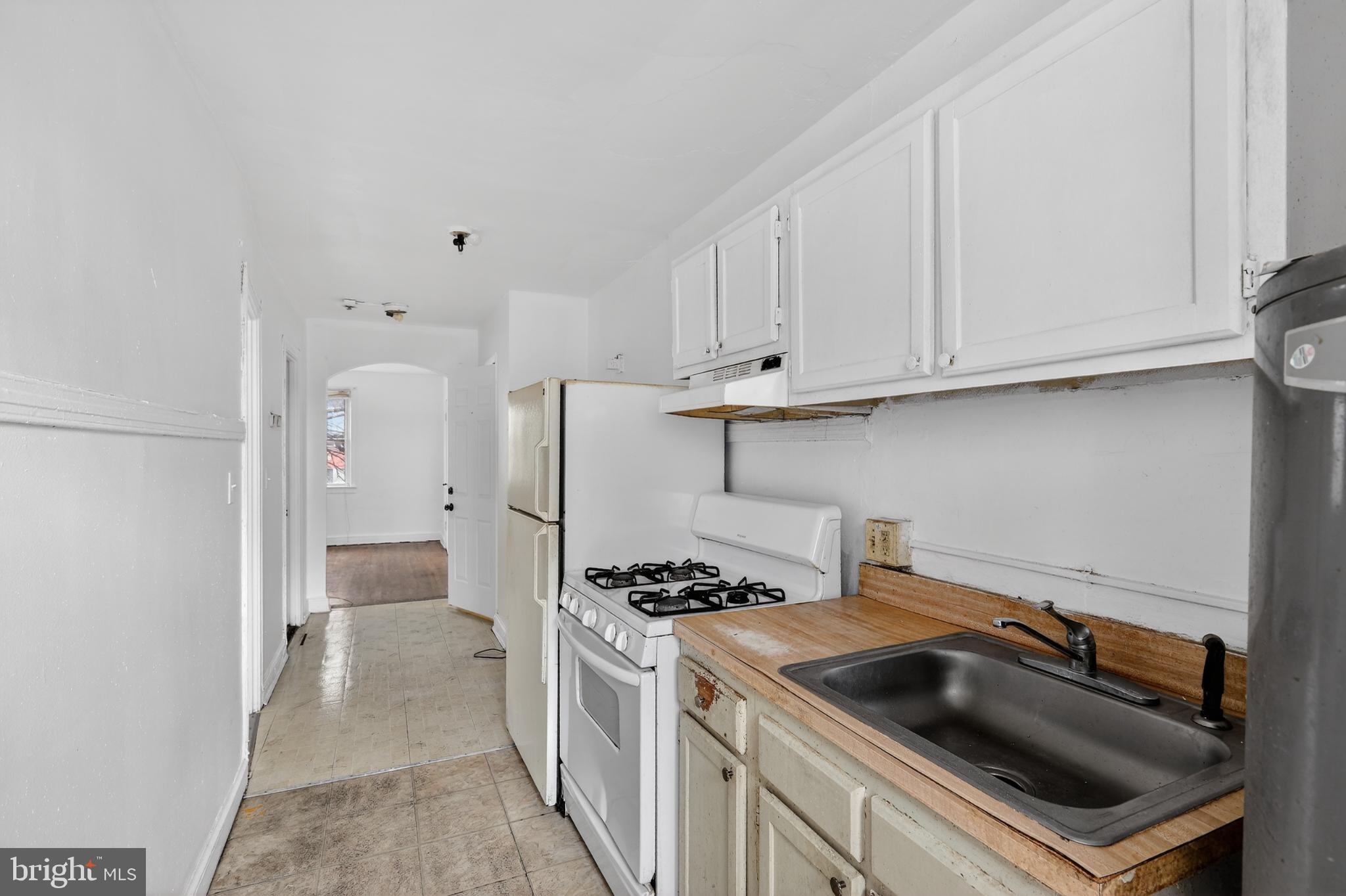 1711 H Street Northeast Washington, DC 20002 - Photo 3 of 15 a kitchen with a stove and a refrigerator
