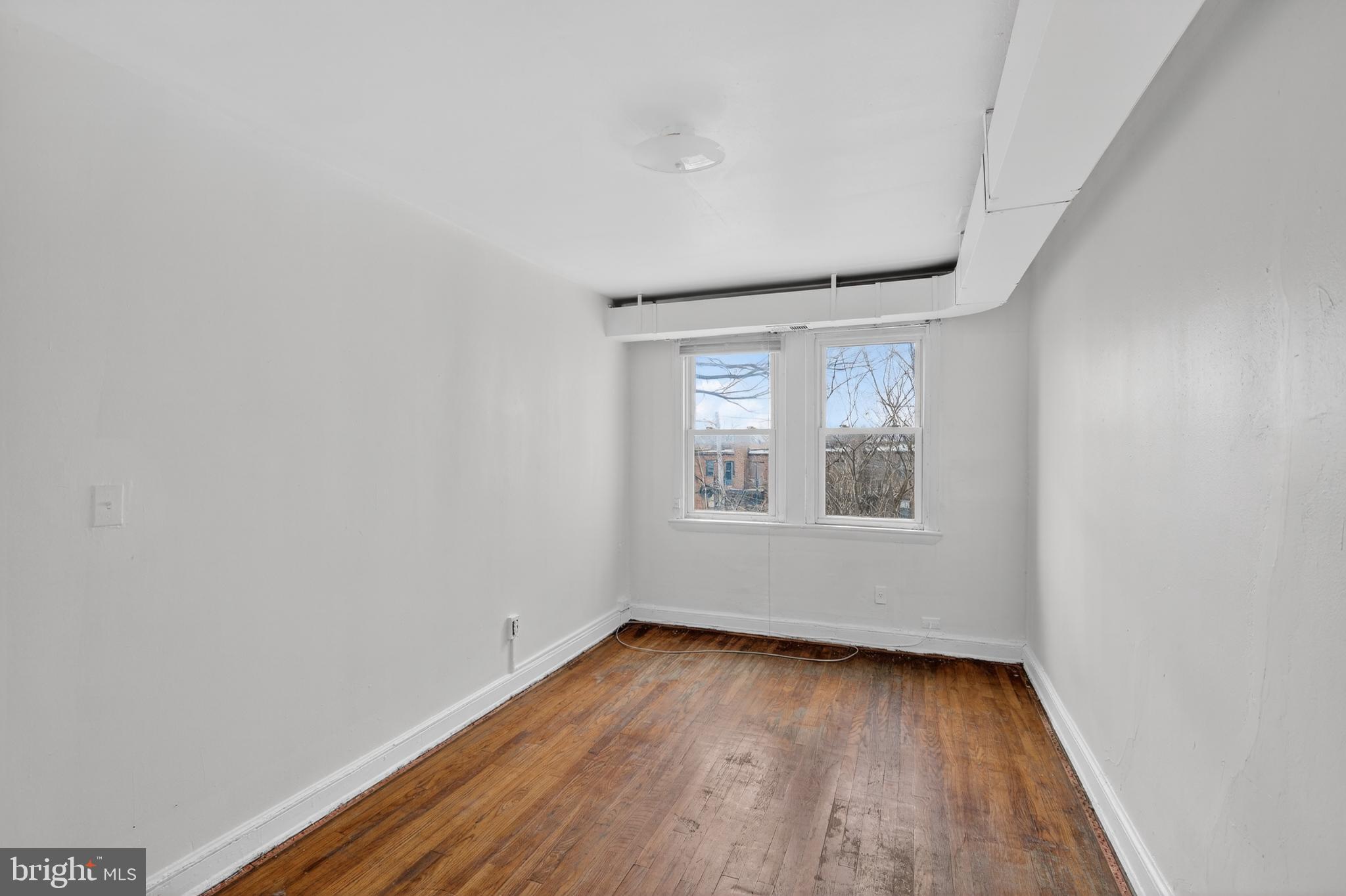 1711 H Street Northeast Washington, DC 20002 - Photo 5 of 15 a view of an empty room with wooden floor and a window