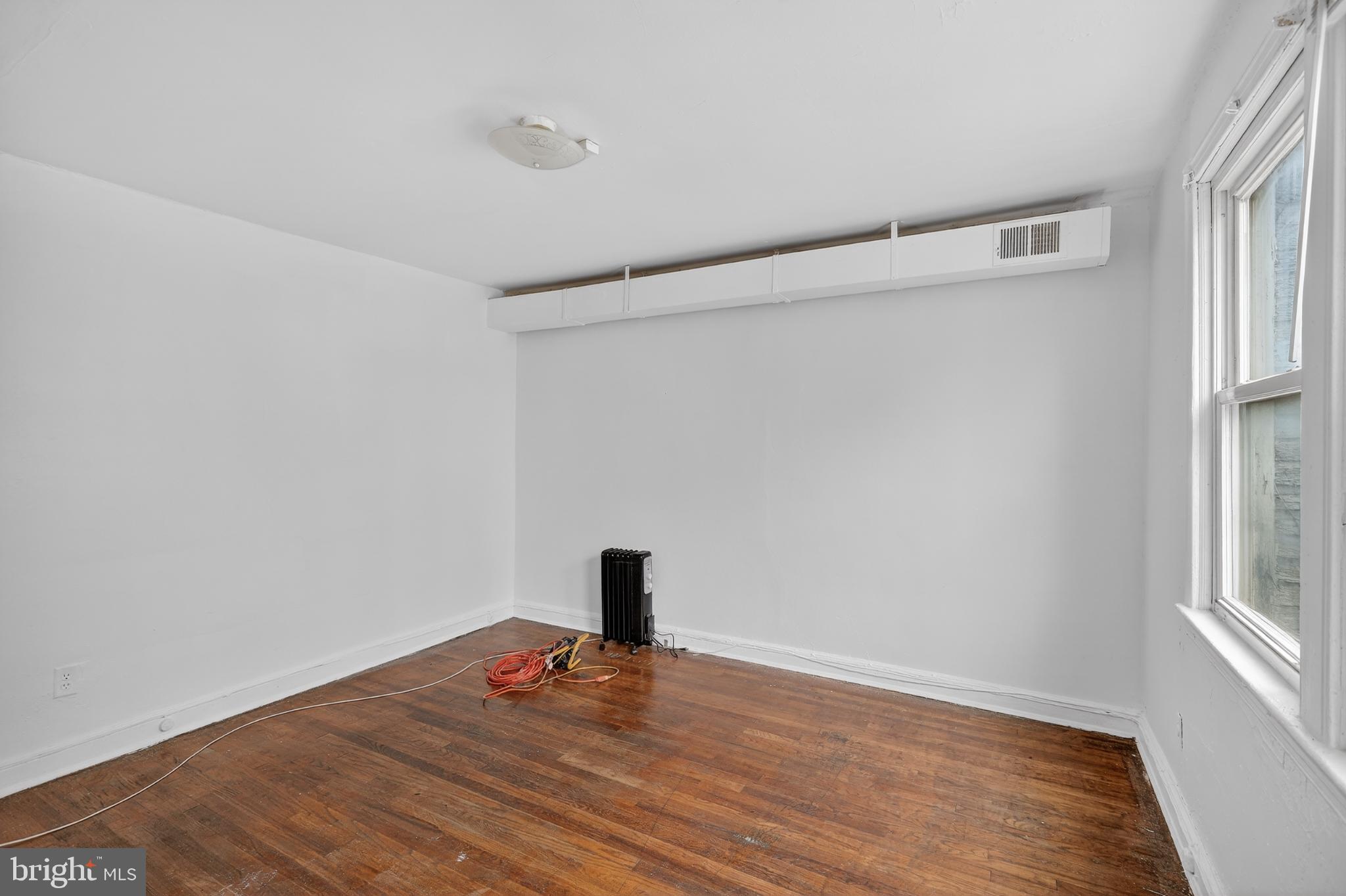 1711 H Street Northeast Washington, DC 20002 - Photo 6 of 15 a view of empty room with wooden floor and fan