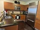 a kitchen with a refrigerator a microwave and stove