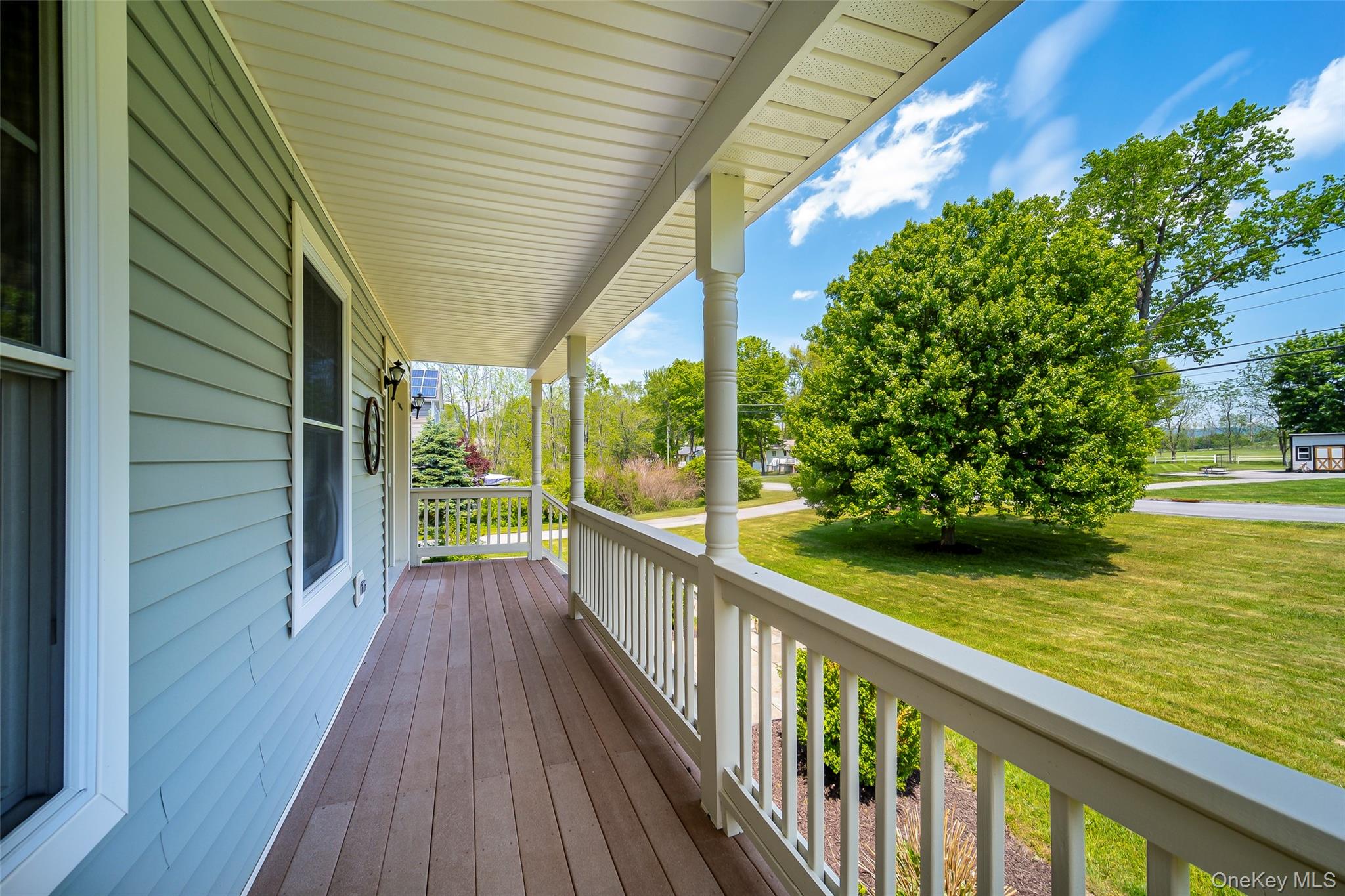20 Lime Ridge Road Poughquag, NY 12570 - Photo 6 of 44 Covered porch featuring wood-finish flooring, white railing, and exterior wall sconces