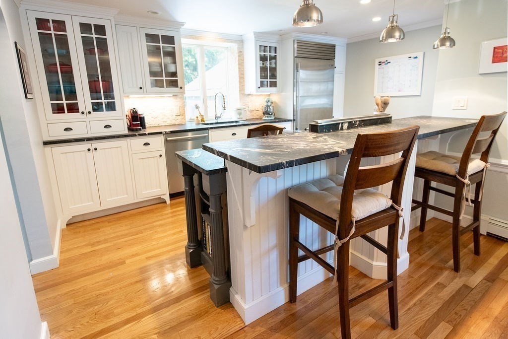 17 Eliot Road Belmont, MA 02478 - Photo 8 of 37 a kitchen with a table chairs sink and cabinets