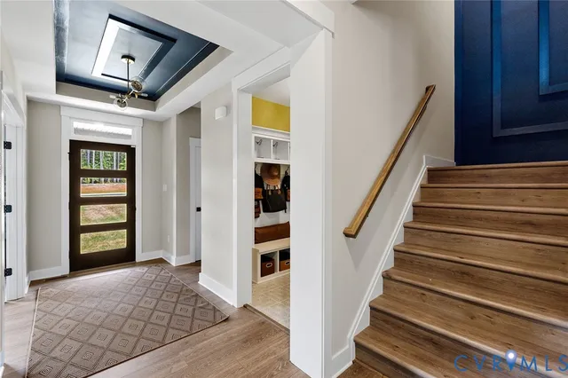 a view of entryway and hall with wooden floor