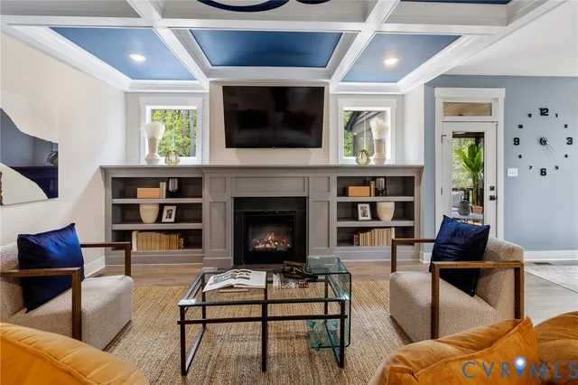 a living room with furniture a flat screen tv and a fireplace