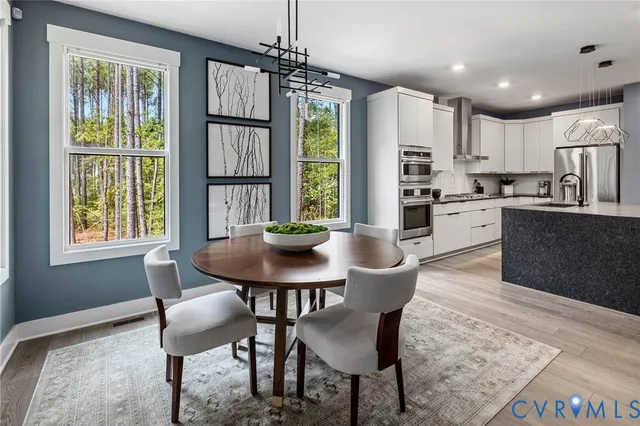 a view of a dining room with furniture window and wooden floor