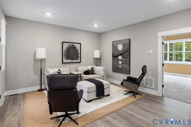 a living room with furniture rug and a window