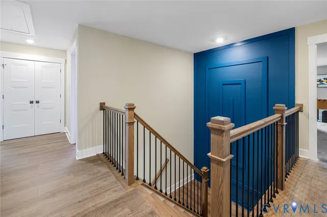 a view of a hallway with wooden floor