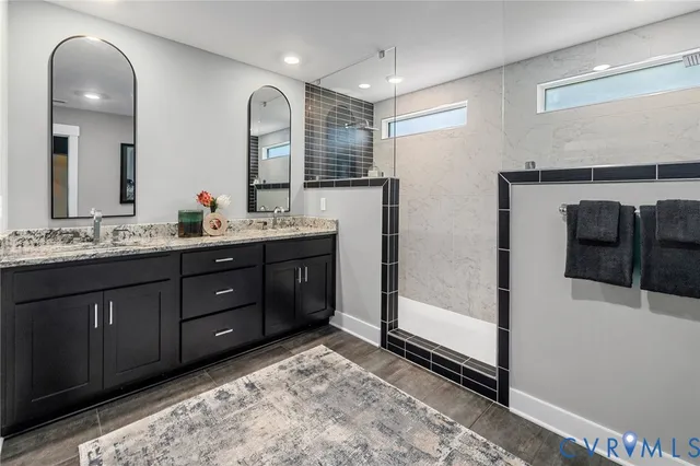 a spacious bathroom with a double vanity sink and a mirror