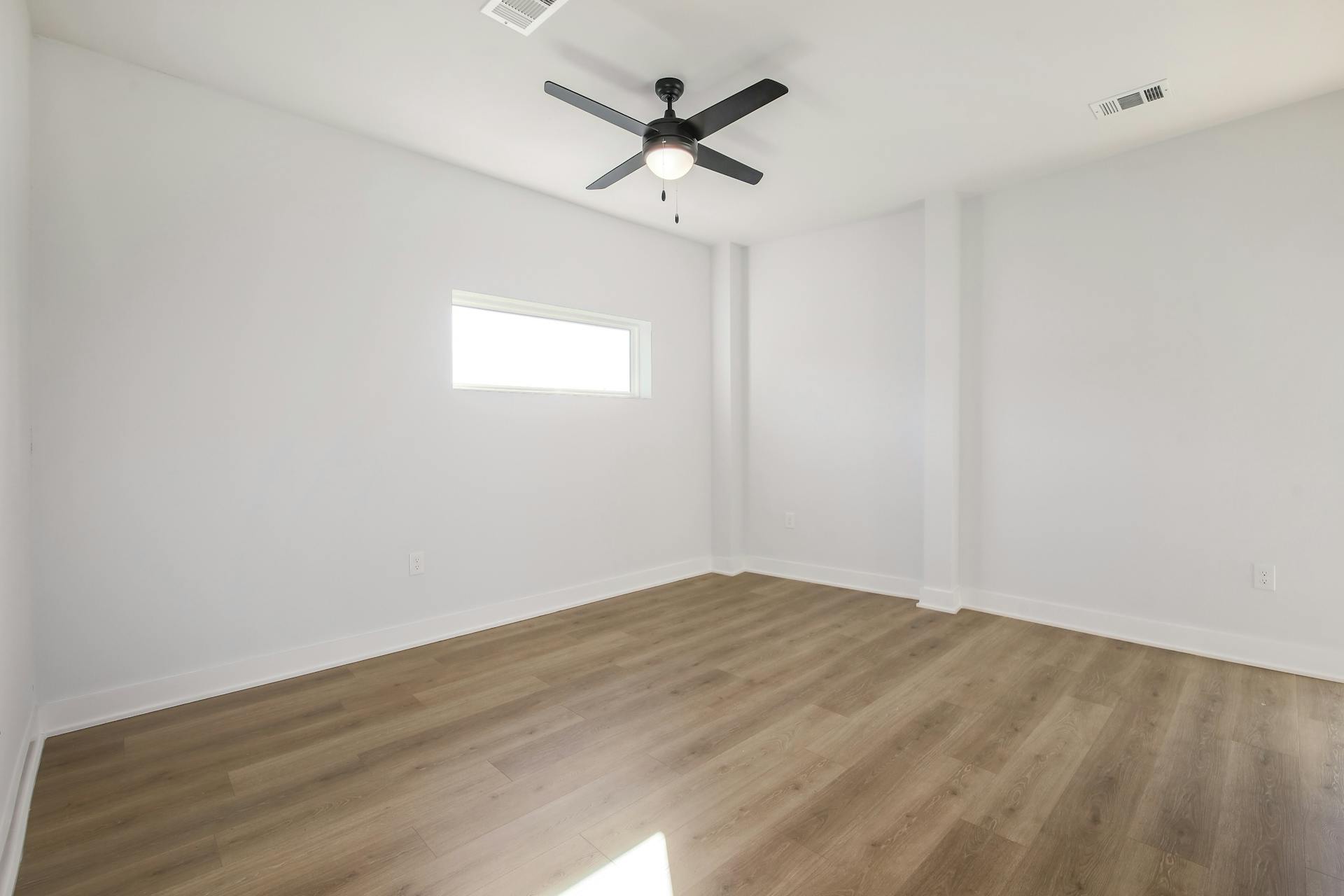 2500 Longview Street, Unit 501 Austin, TX 78705 - Photo 22 of 23 Unfurnished room with wood finished floors and ceiling fan