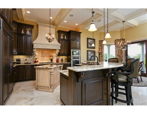 Kitchen - Form, function and beauty define this gourmet s kitchen.  Elegant cabinetry, fine granite counters, Subzero/Wolf/Miele appliances, rich stone backsplashes, separate pantry, center island and bar are simply exquisite.