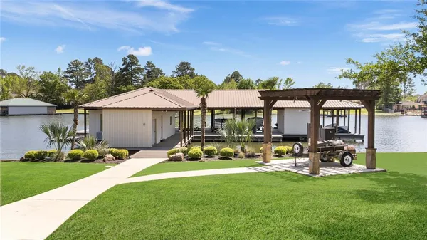 a front view of a house with garden and sitting area