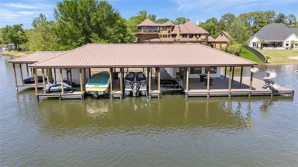 a view of a lake with a house swimming pool and outdoor space