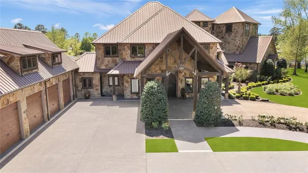 a view of a house with a small yard and a fountain