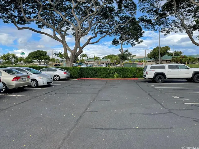 a view of a car parked on the side of a street