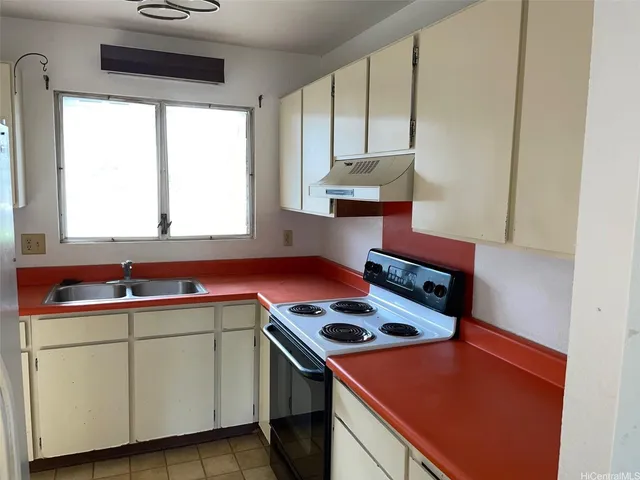 a kitchen that has a stove and a sink