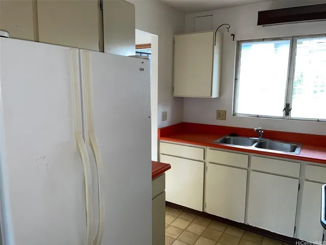 a kitchen with a refrigerator and a sink