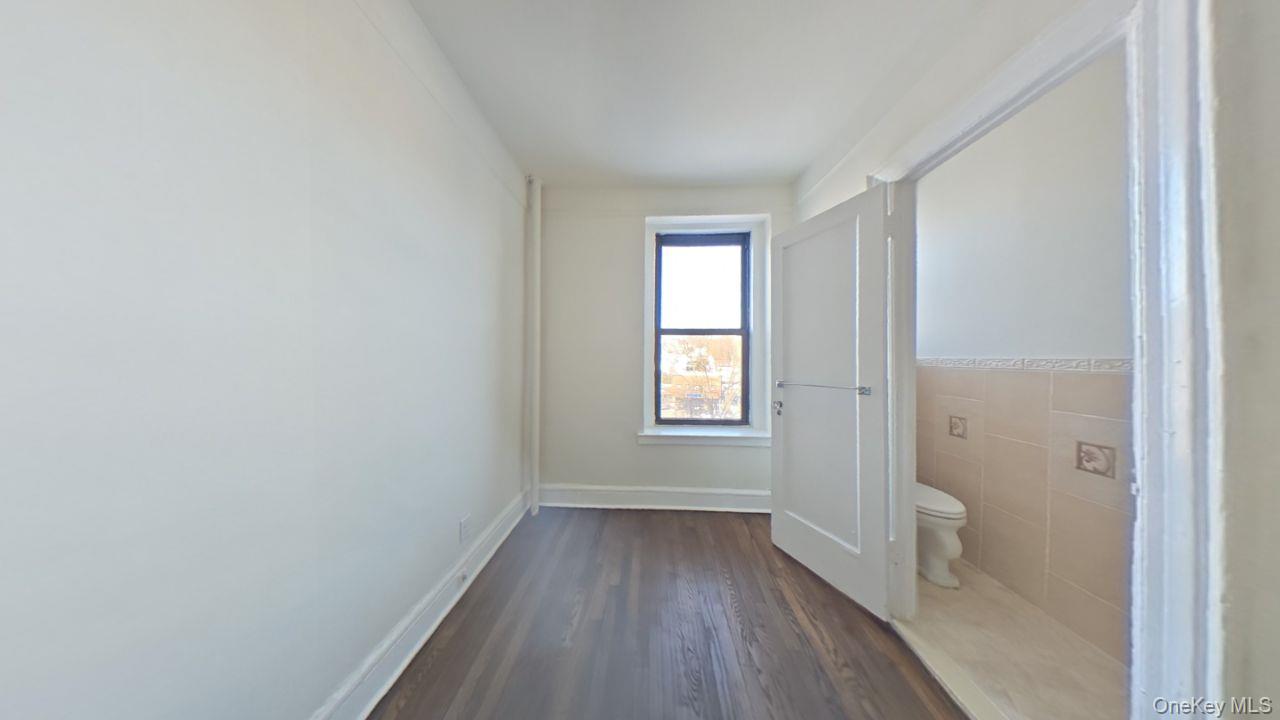 100 Pelham Road, Unit 2B New Rochelle, NY 10805 - Photo 11 of 13 a view of a hallway with wooden floor and closet
