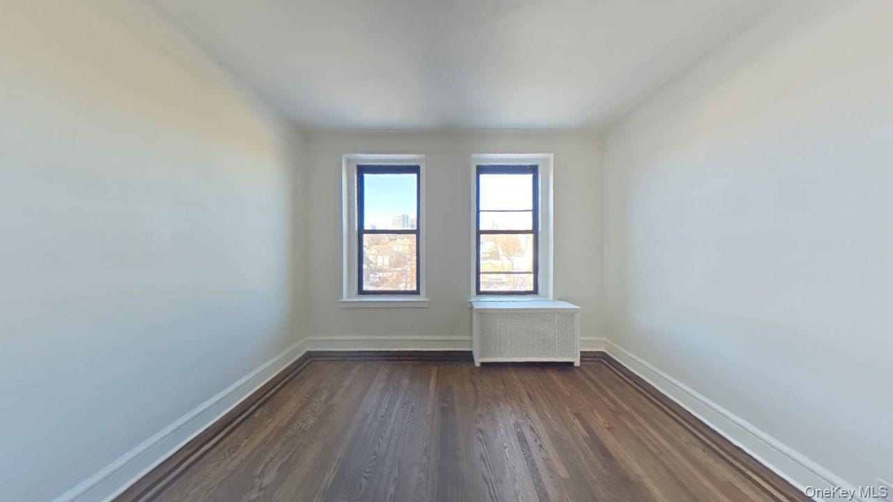 100 Pelham Road, Unit 2B New Rochelle, NY 10805 - Photo 12 of 13 an empty room with wooden floor and windows