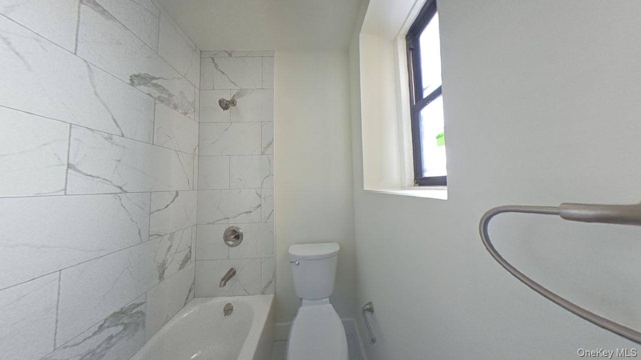 100 Pelham Road, Unit 2B New Rochelle, NY 10805 - Photo 9 of 13 a bathroom with a sink a toilet and shower