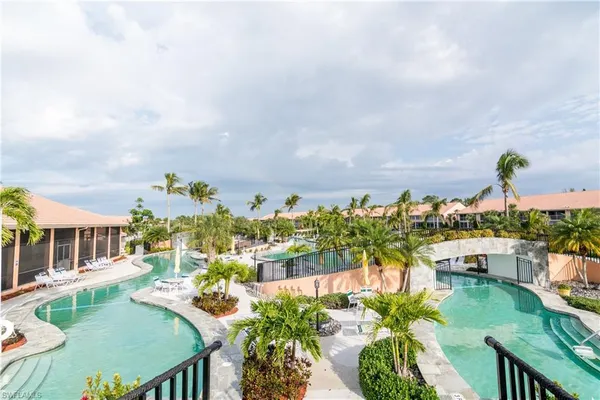 a swimming pool view with a outdoor seating