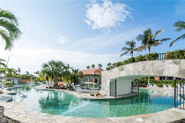 a view of swimming pool with outdoor seating and barbeque oven