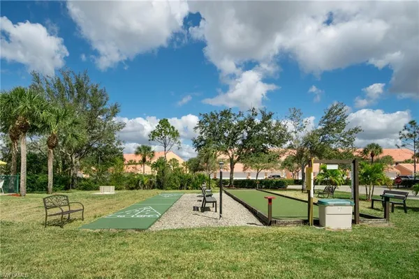 a view of a house with backyard and sitting area