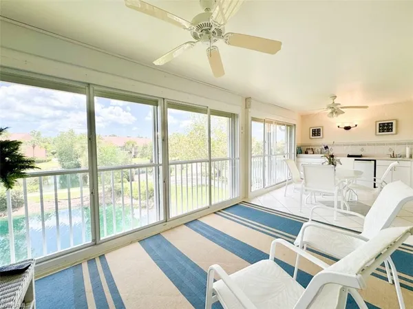 a view of a dining room with furniture a chandelier and wooden floor