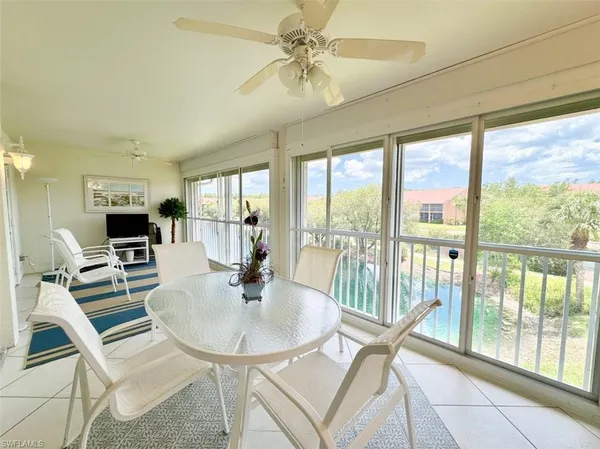 a dining room with furniture a chandelier and wooden floor