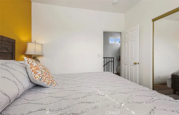 a bedroom with a bed and a lamp