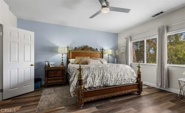 a bedroom with a bed and wooden floor