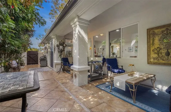 a living room with furniture a fireplace and a potted plant