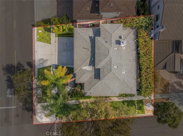 an aerial view of a house with a yard
