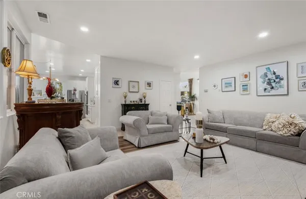 a living room with furniture and a dining table