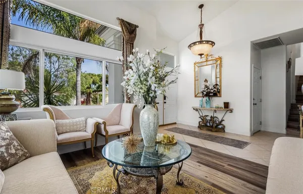 a living room with furniture and a chandelier