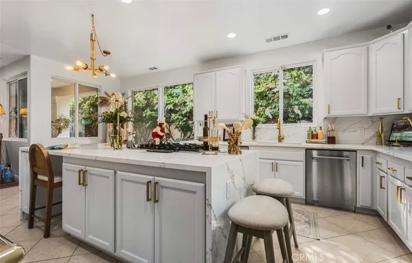a kitchen with a table chairs sink and cabinets