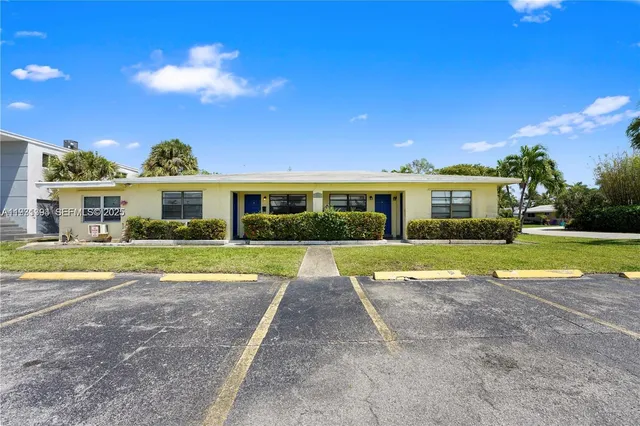 a view of house with swimming pool and a yard