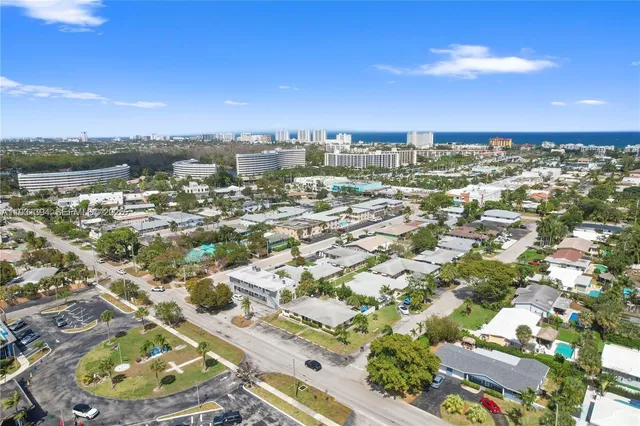 an aerial view of residential houses with outdoor space and street view